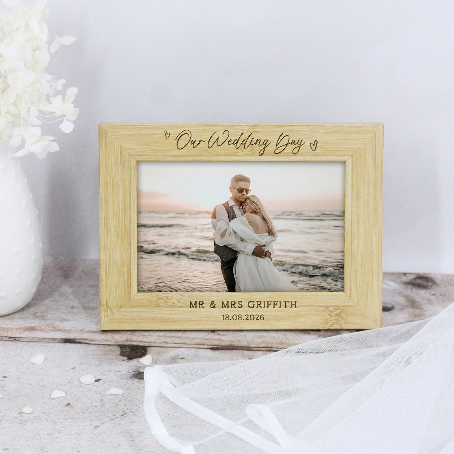 Wooden photo frame with engraved text and a couple on a beach