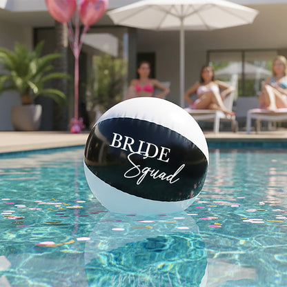 Beach ball with 'Bride Squad' text in a pool with people in the background
