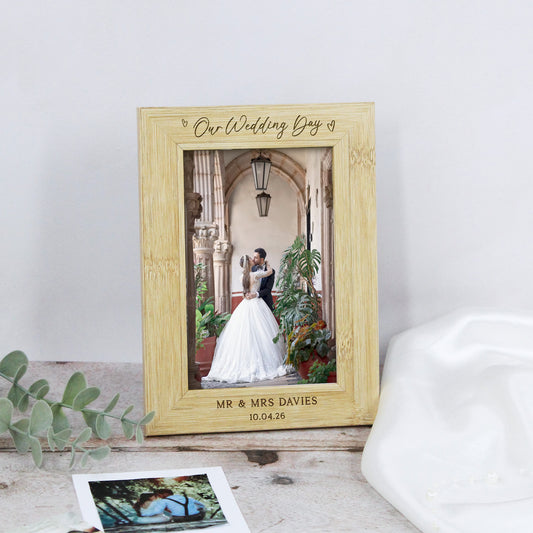 Wooden photo frame with a wedding photograph inside, personalized with names and date.