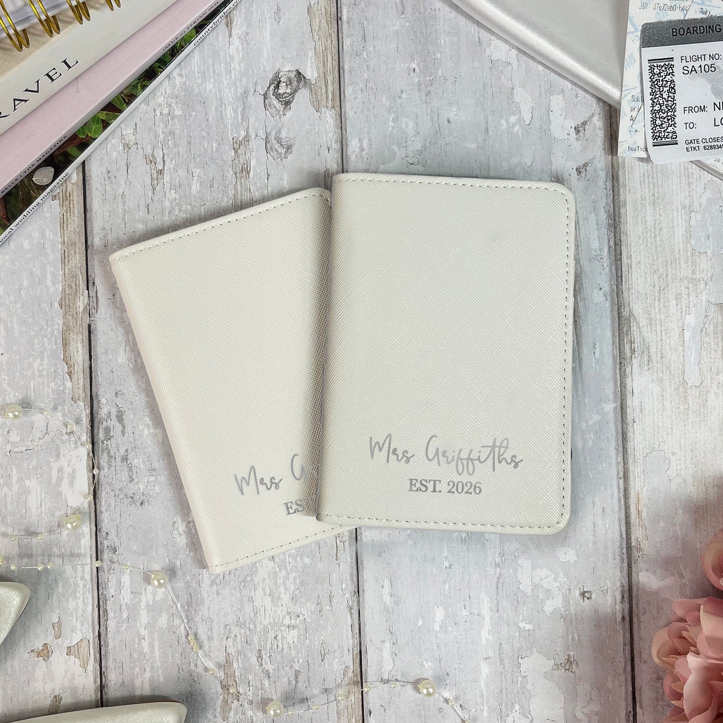 Two beige passport holders on a wooden surface with 'Mrs. Griffiths' text.