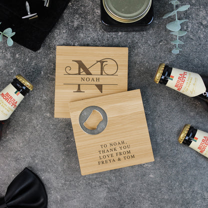 Two wooden coasters with engraved text on a gray surface with beer bottles.