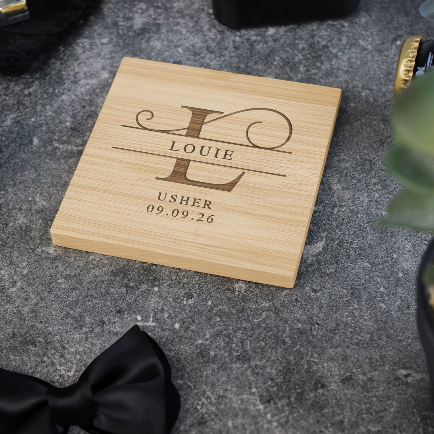 Wooden coaster with engraved text on a gray surface