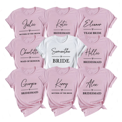 Set of pink and white t-shirts with names printed on them, including 'Bride', 'Bridesmaid', and 'Mother of the Groom'.