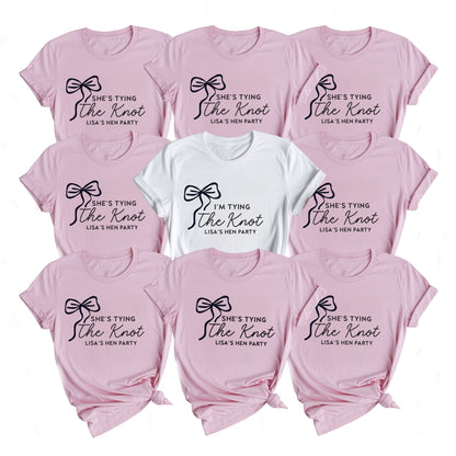 Set of pink t-shirts with 'She's tying the knot' text, suitable for a hen party.