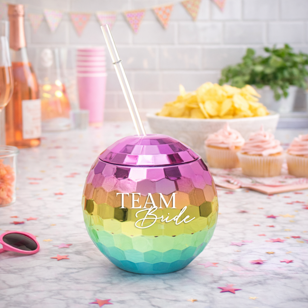 Multicolored tumbler with 'Team Bride' text on a festive table setting.